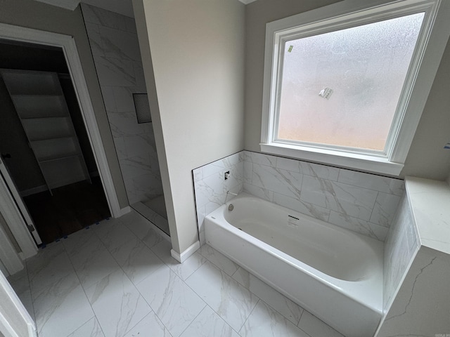 bathroom featuring shower with separate bathtub and a wealth of natural light