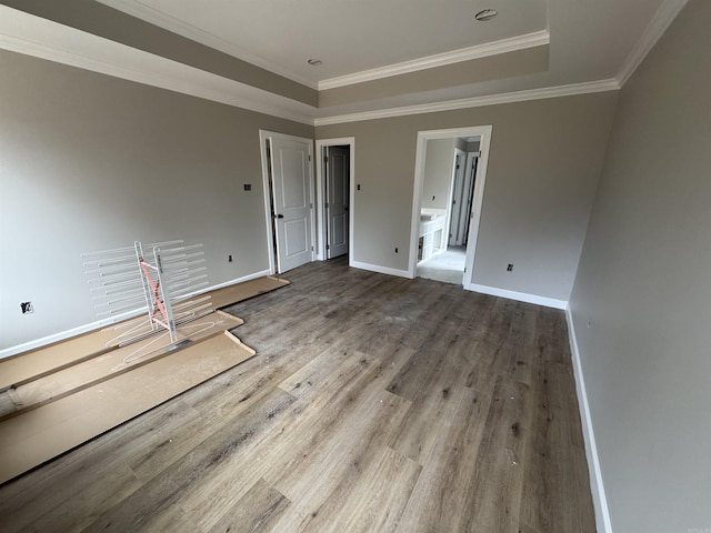 unfurnished room featuring hardwood / wood-style floors and crown molding