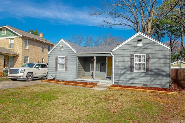 view of front of home with a front yard and covered porch