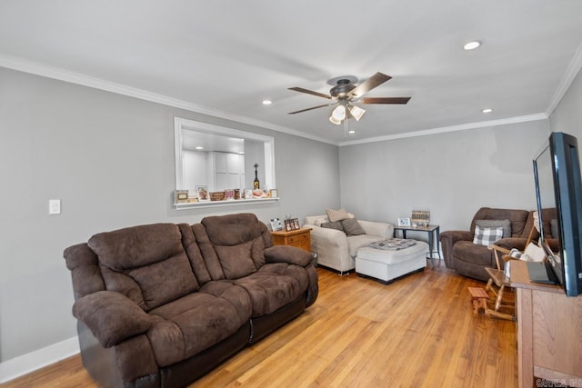 living room with crown molding, ceiling fan, and light wood-type flooring