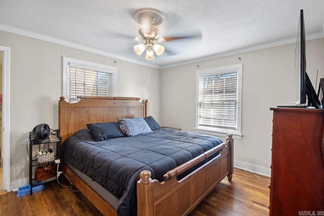 bedroom featuring crown molding, multiple windows, dark wood-type flooring, and ceiling fan