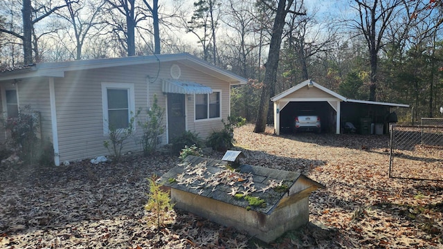 exterior space featuring a carport, a garage, and an outdoor structure