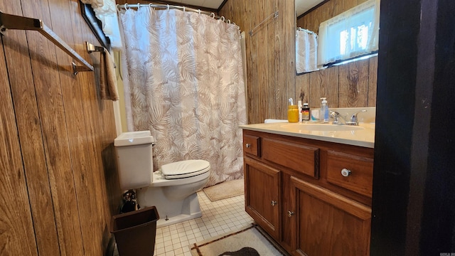 bathroom with wood walls, tile patterned flooring, vanity, and toilet