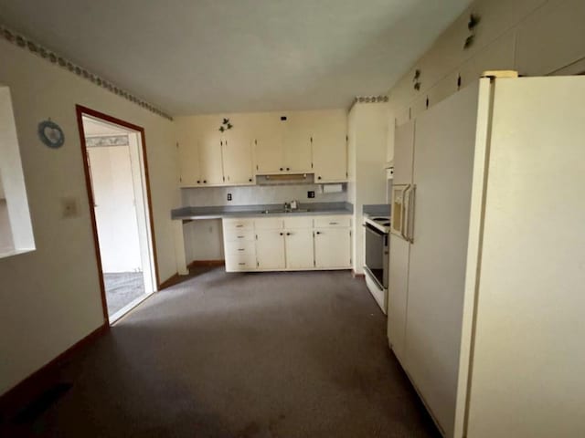 kitchen featuring white cabinetry, sink, white appliances, and dark colored carpet