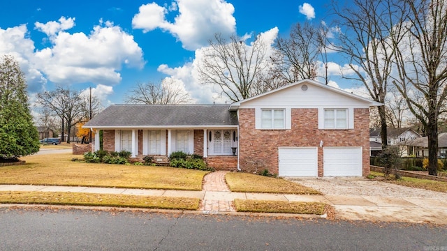 split level home featuring a front yard and a garage