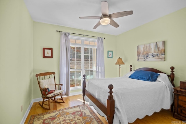 bedroom with ceiling fan and light hardwood / wood-style floors