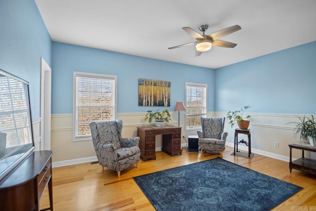 sitting room featuring hardwood / wood-style floors and ceiling fan