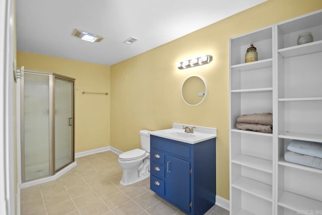 bathroom featuring tile patterned flooring, vanity, toilet, and a shower with shower door