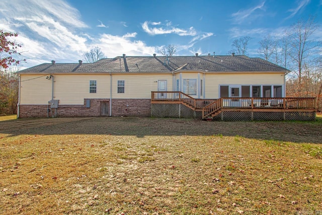 back of property featuring a deck and a yard