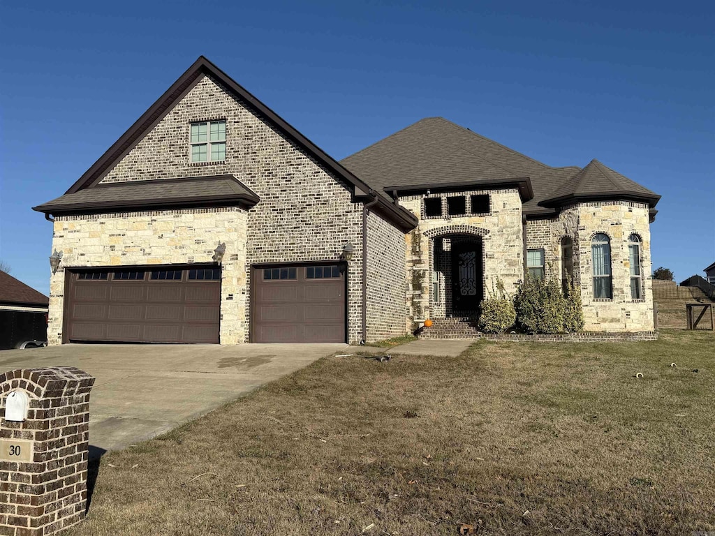 french country inspired facade featuring a front lawn