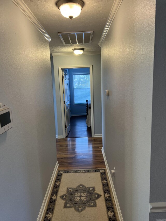 hallway with crown molding and dark hardwood / wood-style flooring