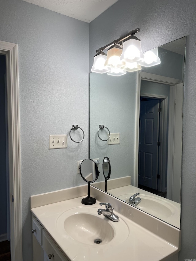 bathroom featuring vanity and a textured ceiling