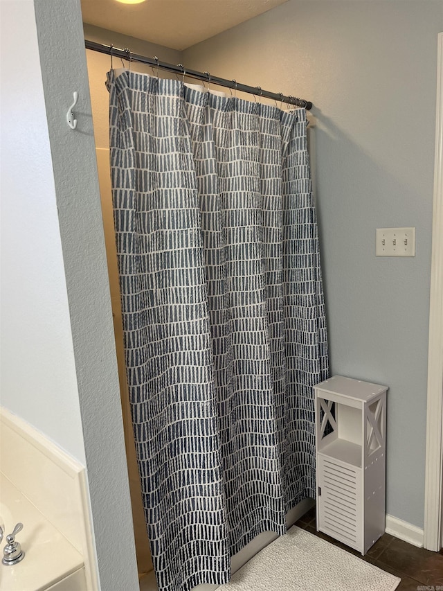 bathroom with tile patterned floors and curtained shower