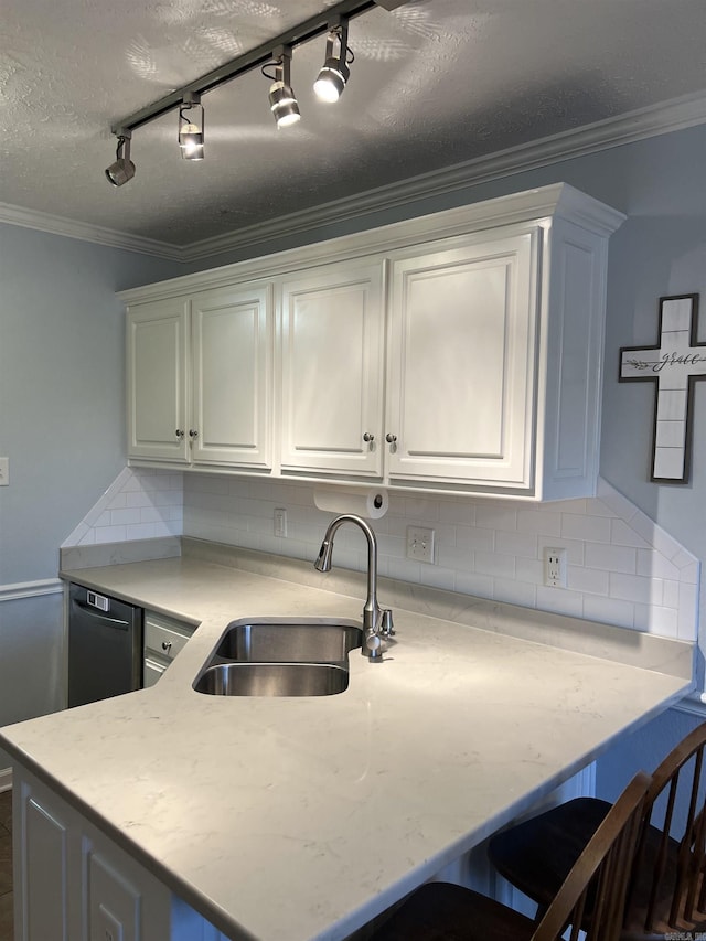 kitchen featuring white cabinets, backsplash, and track lighting