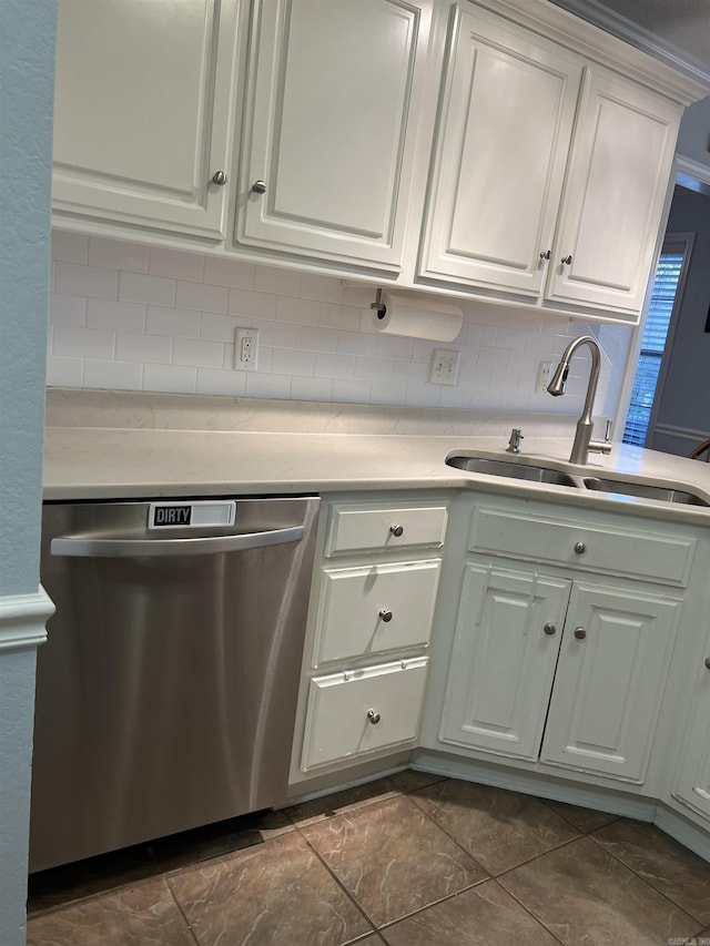 kitchen featuring dishwasher, white cabinets, sink, ornamental molding, and tasteful backsplash