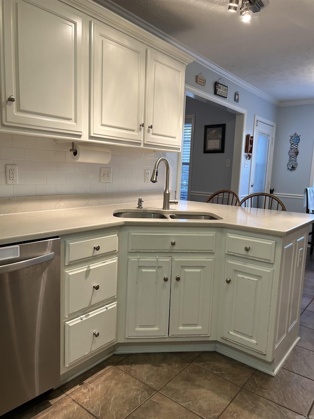 kitchen featuring dishwasher, sink, kitchen peninsula, decorative backsplash, and ornamental molding