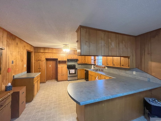 kitchen with sink, electric range, ceiling fan, black dishwasher, and kitchen peninsula