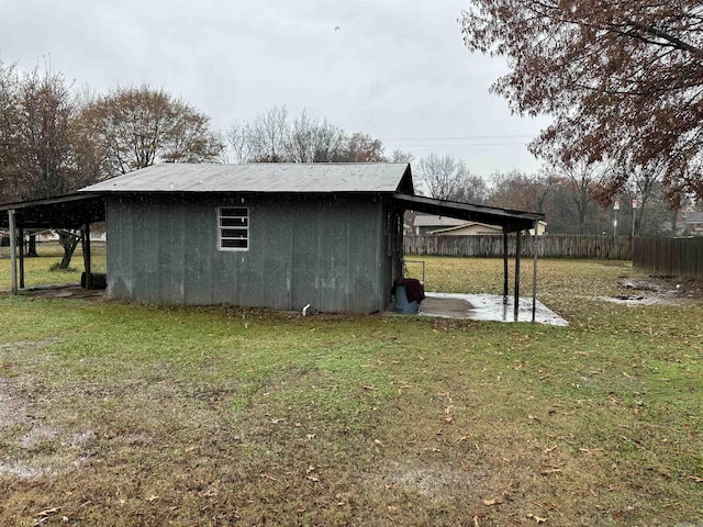 view of outbuilding with a yard