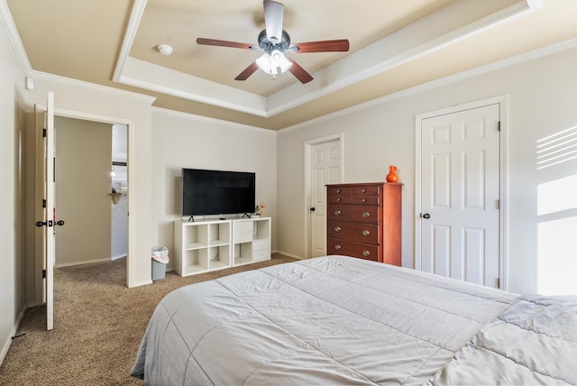 carpeted bedroom with ceiling fan, a raised ceiling, and ornamental molding