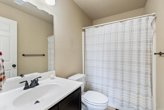 bathroom with vanity, a shower with shower curtain, and toilet