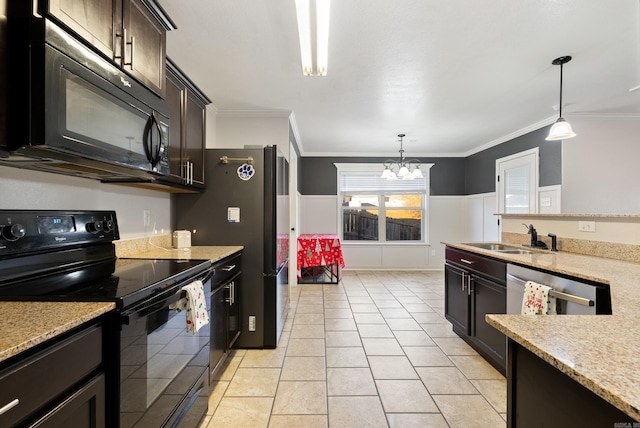 kitchen with hanging light fixtures, an inviting chandelier, black appliances, and sink