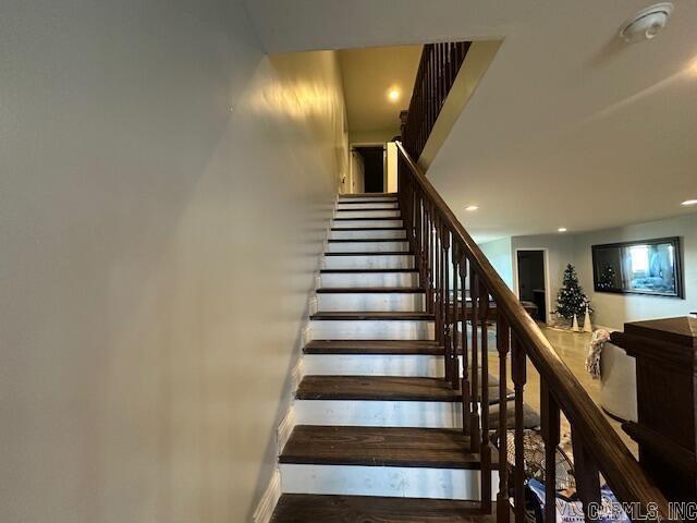 stairs featuring wood-type flooring