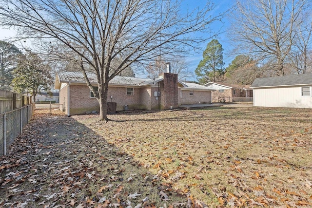 rear view of house with a storage shed