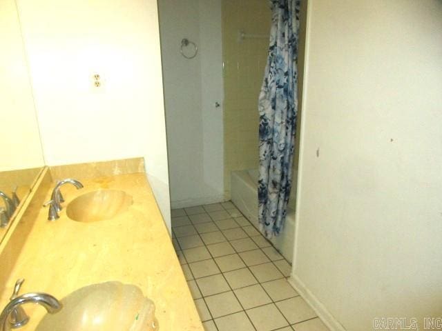 bathroom with sink, shower / tub combo, and tile patterned flooring