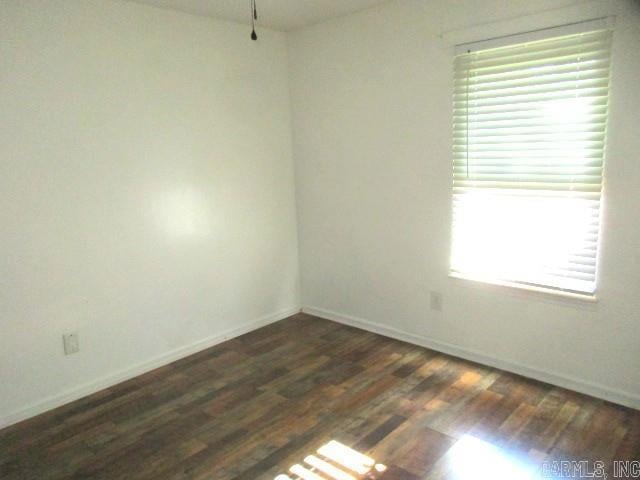 empty room with dark hardwood / wood-style floors