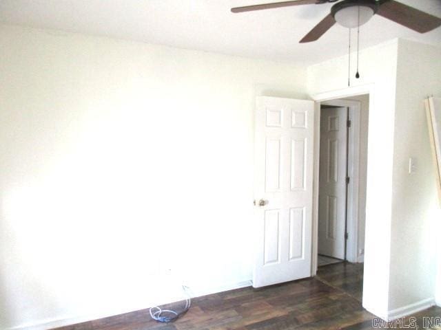 empty room featuring dark hardwood / wood-style floors and ceiling fan