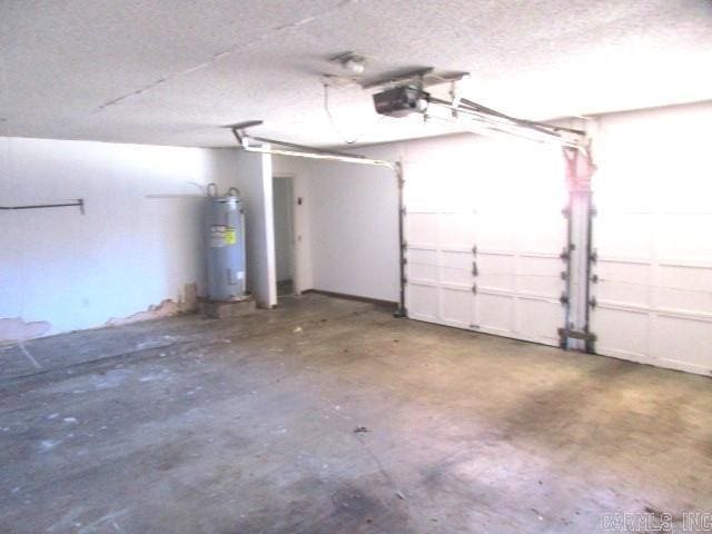 garage with water heater and a garage door opener