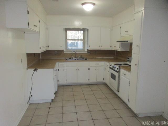 kitchen with light tile patterned floors, white cabinetry, white electric stove, and sink