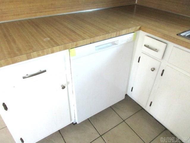 details with wooden counters, white dishwasher, and white cabinetry