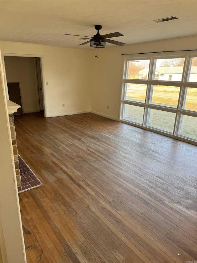 empty room featuring hardwood / wood-style flooring and ceiling fan