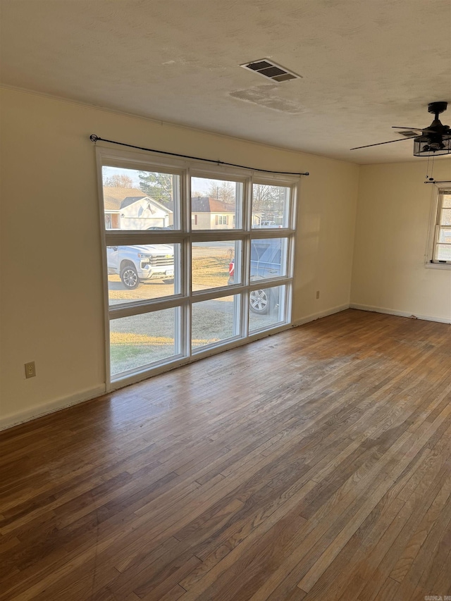 unfurnished room featuring hardwood / wood-style flooring and ceiling fan