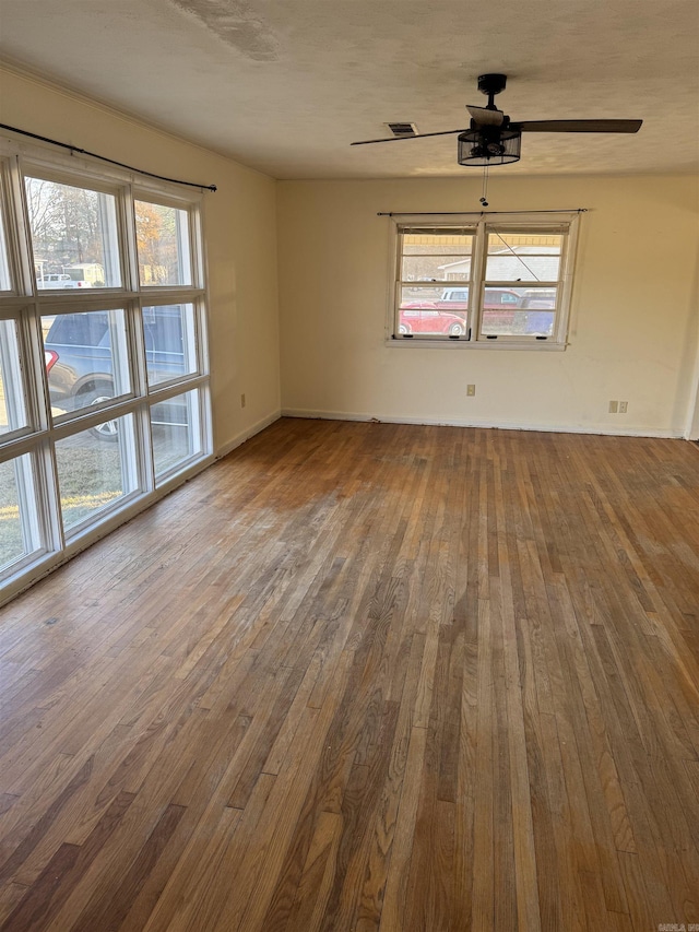 spare room featuring hardwood / wood-style flooring and ceiling fan