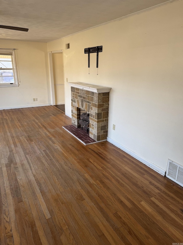 unfurnished living room featuring a fireplace and dark hardwood / wood-style floors