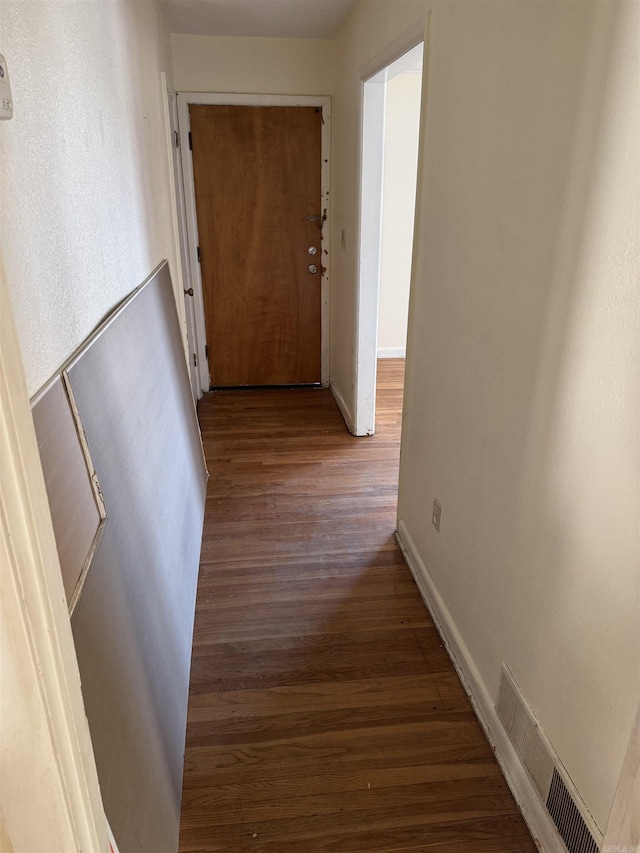 hallway with hardwood / wood-style floors