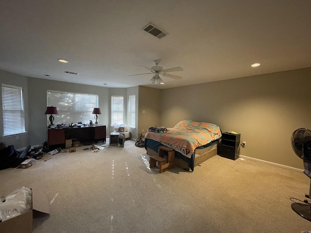 bedroom with ceiling fan and light carpet