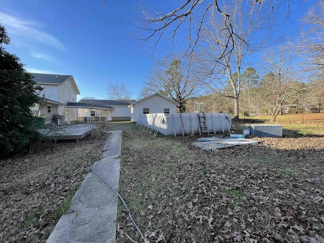 view of yard with a swimming pool side deck