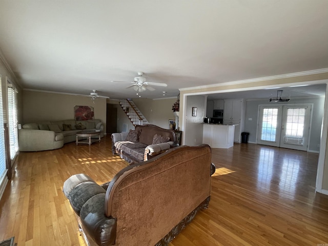 living room featuring ceiling fan, ornamental molding, and hardwood / wood-style flooring