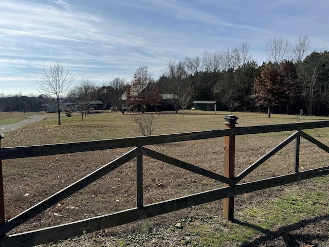 view of gate with a rural view