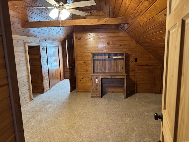 bonus room with wood walls, light colored carpet, and lofted ceiling