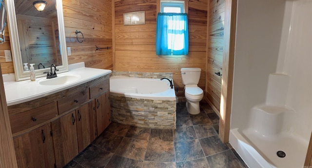 bathroom featuring a bathing tub, wood walls, vanity, and toilet