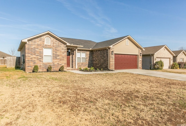 ranch-style home with a garage and a front yard