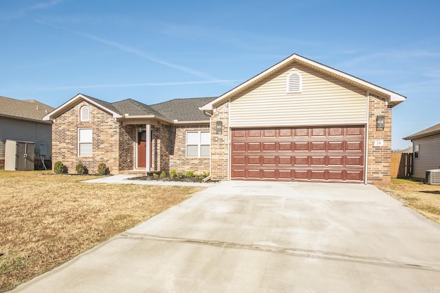 ranch-style home with central AC and a garage