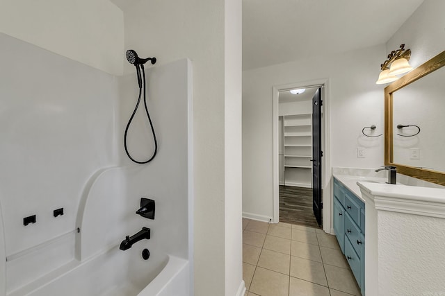 bathroom with tile patterned floors, vanity, and  shower combination