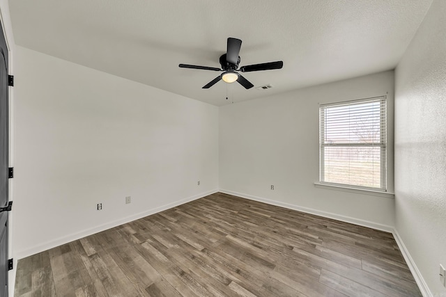 empty room with a textured ceiling, light hardwood / wood-style floors, and ceiling fan