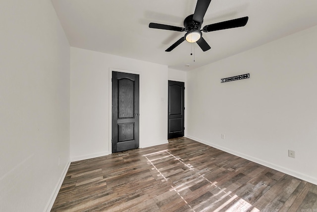 unfurnished bedroom with ceiling fan and dark hardwood / wood-style flooring