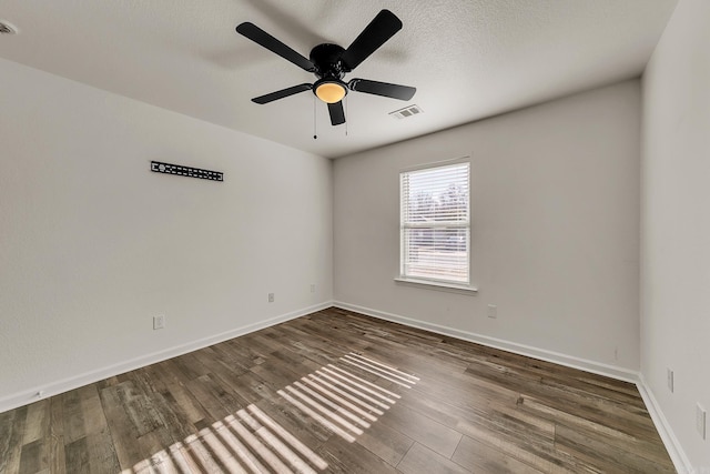 unfurnished room featuring ceiling fan, wood-type flooring, and a textured ceiling